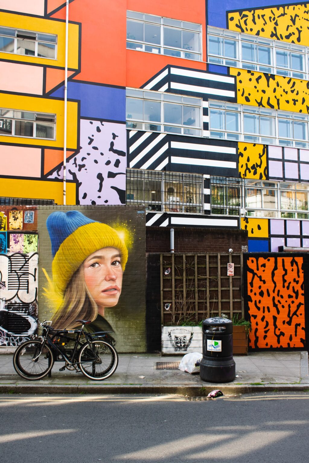 Vibrant mural on Hanbury Street featuring stick figures